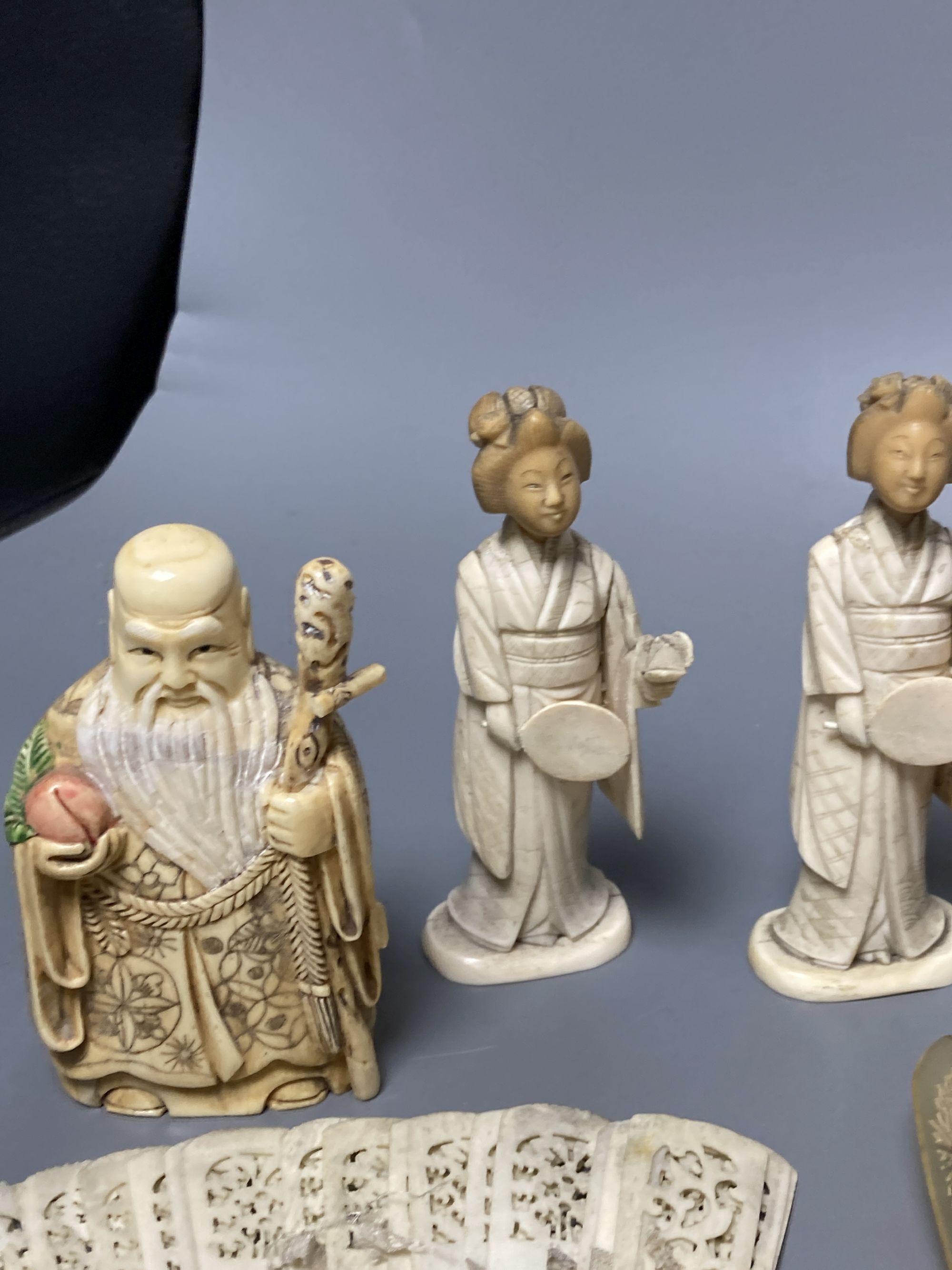 A quantity of bone and ivory carvings including fans and figures